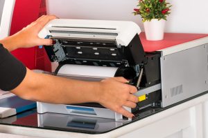 Woman open a sublimation printer in a print shop